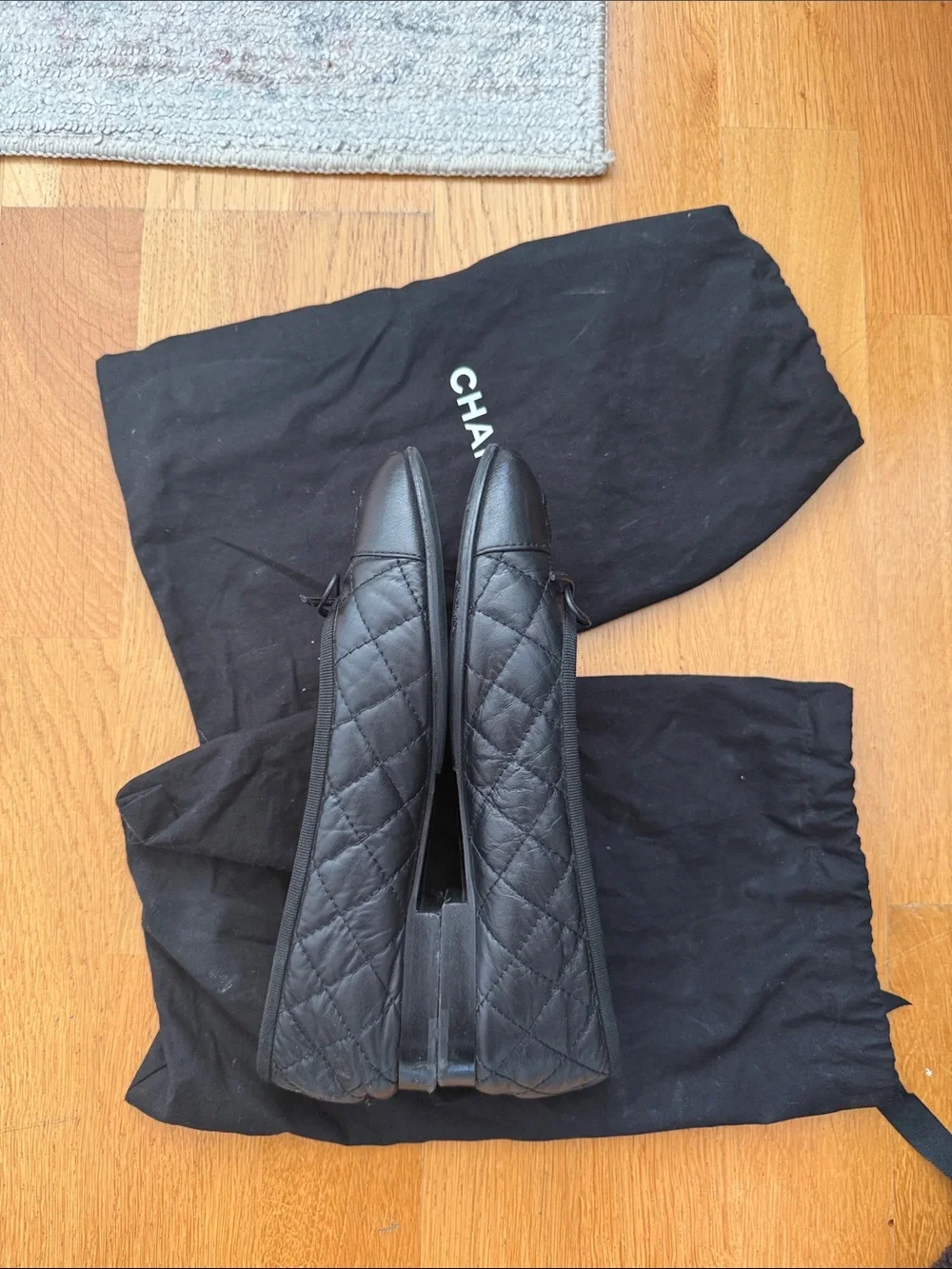 CHANEL Black Quilted Leather Ballet Flats with CC Logo and Bow